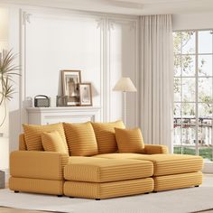 a living room scene with focus on the sofa and pillows in front of the window