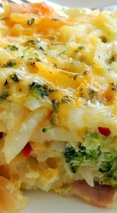 a white plate topped with a casserole covered in broccoli and cheese