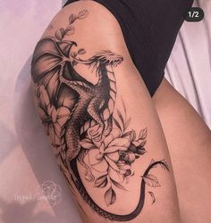 a woman's thigh with a dragon tattoo on it