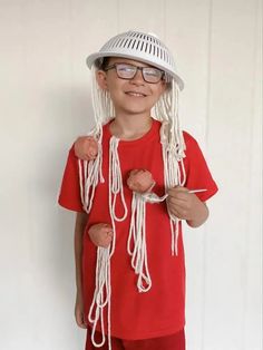 a young boy wearing a white hat and red shirt