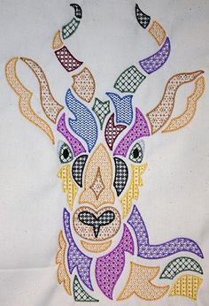 an embroidered deer head with colorful patterns on it