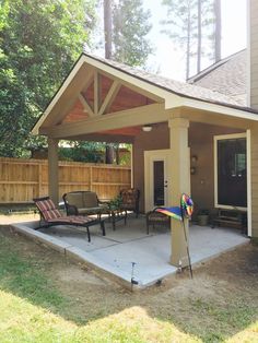 a covered patio with chairs and umbrellas on it