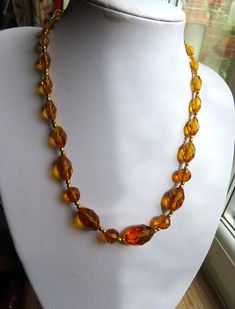 This vintage Golden Yellow glass faceted bead necklace, this necklace is just over 19" long with a roll over fastener.  It has been fitted with a new lobster claw fastener as the older one was broken. This main glass bead is 3/4" and they graduate either side and has these golden beads  spacers.  This is pretty necklace is in a good condition  (22.03.24 A) Vintage Glass Beaded Necklaces With Oval Beads, Vintage Faceted Beaded Necklaces, Vintage Glass Necklaces With Oval Beads, Vintage Formal Beaded Necklaces With Faceted Beads, Vintage Single Strand Crystal Necklace With Round Beads, Vintage Glass Necklace With Oval Beads, Vintage Crystal Necklace With Single Strand Round Beads, Vintage Czech Glass Necklace With Faceted Beads, Vintage Faceted Round Bead Necklaces