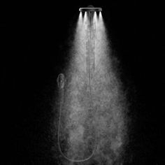 a black and white photo of a shower head with steam coming out of it's side