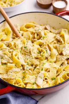 a skillet filled with pasta and chicken