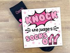 a sign that says knock the judge's socks off on top of a wooden floor