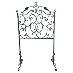 a wrought iron headboard with wheels and scroll designs on it's sides, isolated against a white background