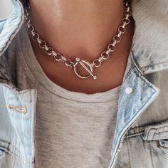 The easiest way to flaunt a rock chic look is by adding a statement choker to your outfit. This super chunky chain choker uses a weighty, thick silver plated chain and oversized toggle clasp to provide that statement piece look.   The chain and toggle clasp are made from durable brass and finished with a thick layer of silver plate.  Why we love it: It's big, it's bold and it will take you anywhere. Wear it to the office, out for drinks with friends or just hanging around the house in a favourit Edgy Silver Jewelry, Silver Choker Chain Necklace With Toggle Clasp, Metal Toggle Choker With Chunky Chain, Silver Chunky Chain Toggle Necklace Choker, Chunky Chain Metal Choker Necklace, Sterling Silver Chunky Chain Choker, Rocker Jewelry, Chunky Silver Jewellery, Chunky Silver Necklace