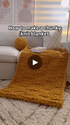 a knitted blanket sitting on top of a white couch