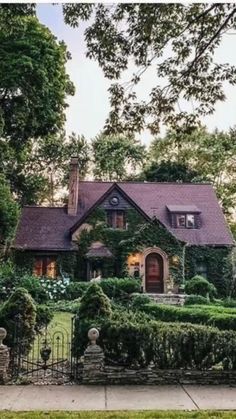 a large house with lots of hedges around it