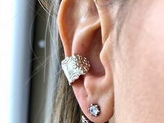 a close up of a person's ear with two piercings on it,