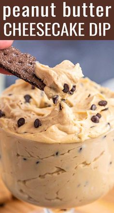 a peanut butter cheesecake dip in a glass bowl with a cracker on top