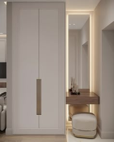 a white closet with a mirror and desk in the corner, next to a bed