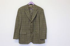 "Mens Tweed Jacket Yves Saint Laurent Jacket Glen Plaid Tweed Blazer new wool blazer country  Large Size Brand: YVES SAINT LAURENT  Great condition   Estimated  size: Large Measurements (lying flat): Chest: - 55 cm / 21.65\" Length - 83 cm / 32.67\" Shoulders: 50 cm / 19.68\" Sleeve:- 62cm / 24.4\" Please check measurements to insure a proper fit. Remember to allow yourself some extra room for movement. You can compare these with something from your closet that fits you well. Condition: Good vintage condition VIEW OUR OTHER VINTAGE APPAREL https://www.etsy.com/shop/HappyVintageHunter?ref=hdr_shop_menu If you have any questions feel free to ask. SHIPPING * I ship worldwide via Priority mail (Latvijas Pasts) from Latvia (EU). * I ship from Europe, so please allow 2 to 4 weeks for the package Plaid Tweed Sport Coat Single Breasted, Plaid Wool Tweed Jacket With Suit Collar, Plaid Wool Tweed Jacket With Notch Lapel, Plaid Tweed Single-breasted Sport Coat, Plaid Wool Tweed Jacket With Pockets, Saint Laurent Jacket, Mens Wool Coats, Wool Coats, Glen Plaid