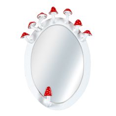 a mirror with red mushrooms on it and white trim around the edges, in front of a white background