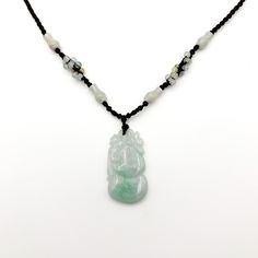 This is a high grade jade pendant. It is extremely beautiful and high grade Jadeite jade. The jade is carved in the form of a peach, which in Chinese mythology symbolize great longevity and health. On the top left is a carved bat sitting on top of the peach. The bat symbolize great wealth. Together - the bat on top of the peach means the wearer will have great health and wealth in Chinese mythology. The stone on this piece has striking green hues enveloping the primary yellow jade color, which g Jade Gemstone Amulet Necklace, Jade Gemstone Amulet Necklaces, Jade Amulet Necklaces With Gemstones, Carved Jade Pendant Necklace, Chinese Mythology, Nephrite Jade, Jade Necklace, Natural Jade, Jade Pendant