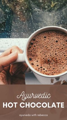 a cup of hot chocolate sitting on top of a table