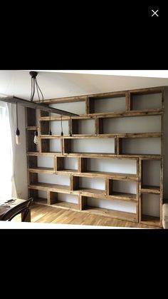 an empty room with some bookshelves on the wall