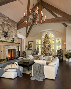 a living room filled with lots of furniture and a fire place in the middle of it