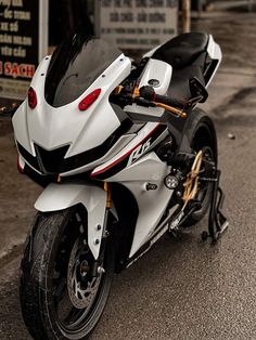 a white and black motorcycle parked on the street