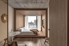 a bedroom with wooden floors and white walls