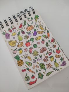 a notebook with drawings of fruits and vegetables on it