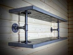 an industrial style shelf with two pipes on the top and one pipe at the bottom