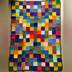 a multicolored quilt hanging on the wall