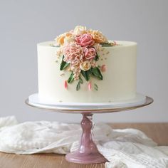 a white cake with pink flowers on it