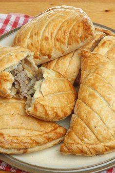 several pastries on a plate with a red and white checkered table cloth