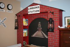 there is a red brick building with a clock on the wall and a sign that says london's station