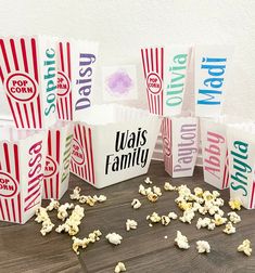 popcorn bags filled with different flavored snacks on top of a wooden table next to other boxes