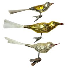 three metal birds sitting on top of each other