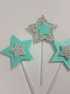 three star shaped lollipop sticks with glitter on them