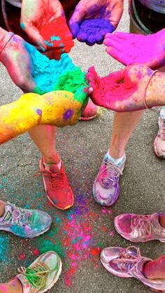 several people with their feet covered in colored powder and holding onto each other's hands