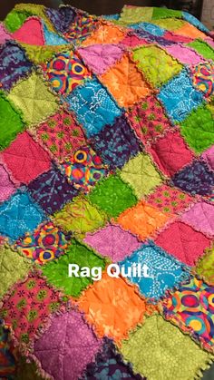 a colorful quilt on top of a bed with the words rag quilt written below it