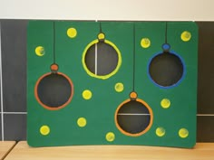 a green board with yellow and blue circles hanging from it