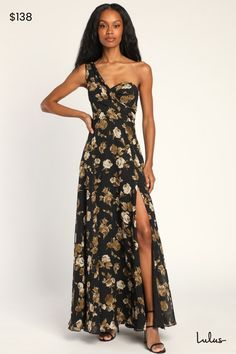 a woman wearing a black and gold floral print dress with one side slited out