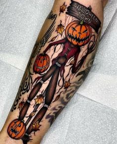 a person with a halloween themed tattoo on their leg