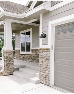 a house with two garage doors and steps leading up to the front door