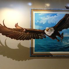 an eagle is flying in front of a painting