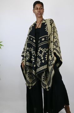 This gorgeous shawl is an easy throw and go addition. It’s tribal elements are woven into the garment. Great way to add a cozy, yet stylish finish to any outfit. Choose the black side or tan side…either way you are sure to look culturally chic. Belt not included. One Size Fits All Bohemian Brown Shawl With Traditional Drape, Ruana Celtic Shawl, Black Bohemian Poncho Shawl, Luxury Black Bohemian Shawl, Aztec Print Scarf, Chic Belt, Black Side, One Size Fits All, The Black