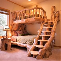 a bed made out of logs with a ladder to the top and stairs up to the bottom