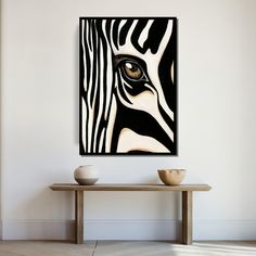 a painting on the wall above a table with two bowls in front of it and a zebra's eye