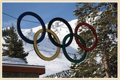 the olympic rings are hanging in front of a snowy mountain