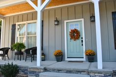 the front porch is decorated with flowers and wreaths