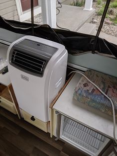 an air conditioner sitting next to a window