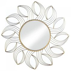 a round mirror sitting on top of a metal frame