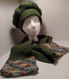 a crocheted hat and scarf are on display