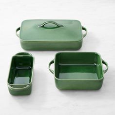 three green square dishes with handles and lids